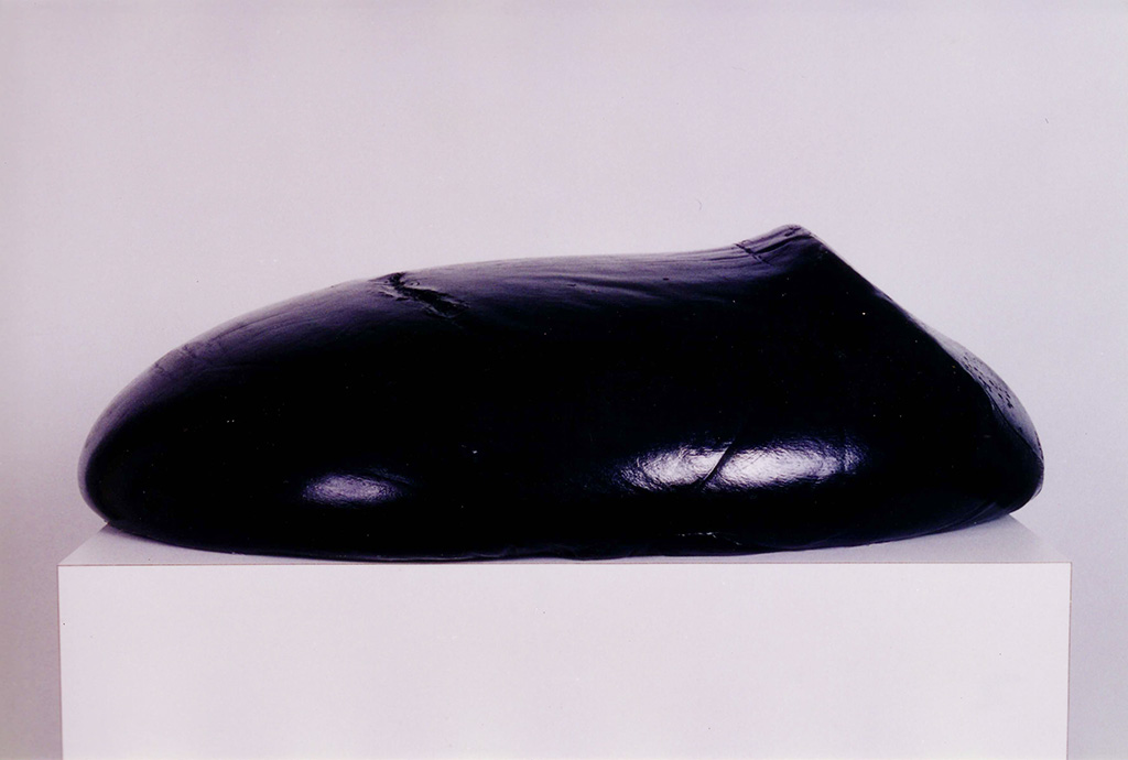 A black stone-shaped sculpture